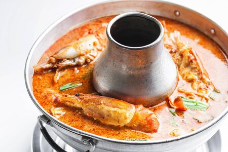 Prawn and lemon grass soup with mushrooms or tom yam kung in hotpot の写真素材