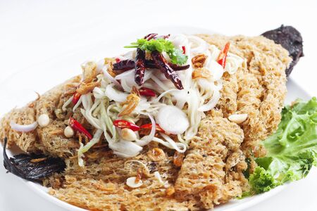 Crispy catfish salad with green mango on white background の写真素材