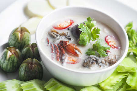 Thai styled Chilli sauce and vegetables on wooden plate の写真素材