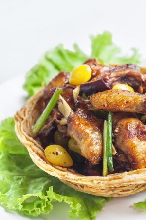 Fried chicken in taro basket on white background の写真素材