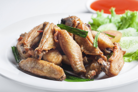 Fried chicken in dish on white background の写真素材