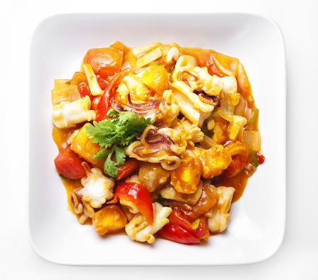 Stir-fried salted egg with squid in dish on white background の写真素材