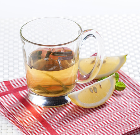 Lemon tea in glass on red chintz           の写真素材