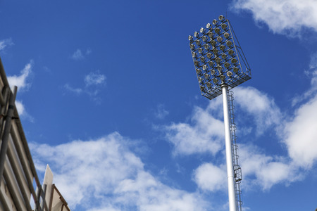 Stadium of light and cloudy blue sky background  の写真素材