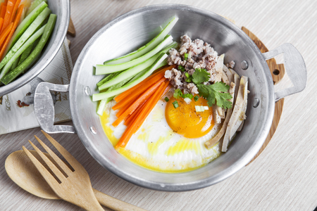 Breakfast with Fried eggs and mince pork and vegetable on pan の写真素材