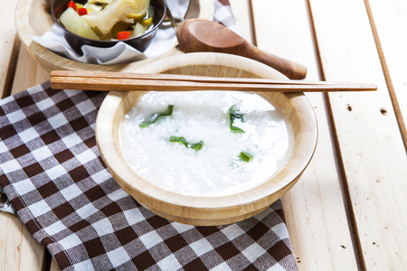 Gruel with hot and sour  pickle on wooden background     の写真素材
