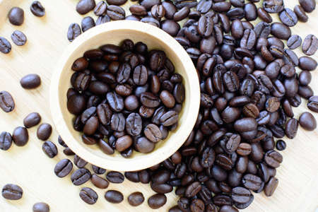 Coffee beans on a wooden  background.