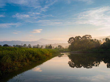 mountain forest nature and reflectation on river with blue sky sunrise in the moning, landscape concept.の写真素材