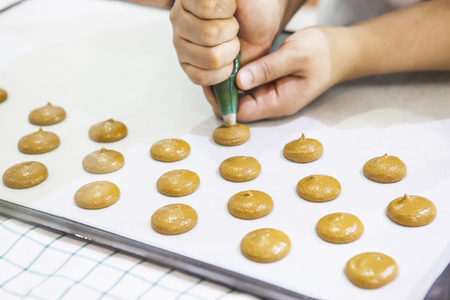 Macaroons on steel kitchen tableの写真素材