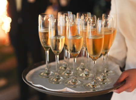 Full glasses of champagne on trayの写真素材