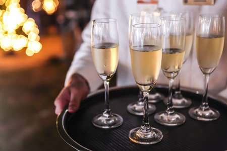 Full glasses of champagne on trayの写真素材