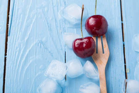 fresh cherries on wooden tableの写真素材
