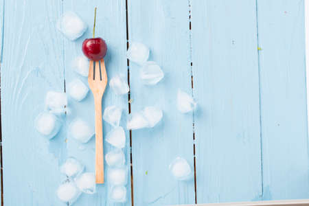 fresh cherries on wooden tableの写真素材
