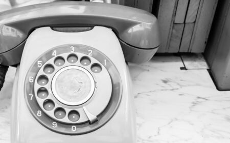 Retro rotary telephone on wood tableの写真素材