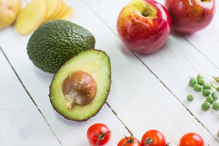food background with fresh organic avocado on old wooden table, top view