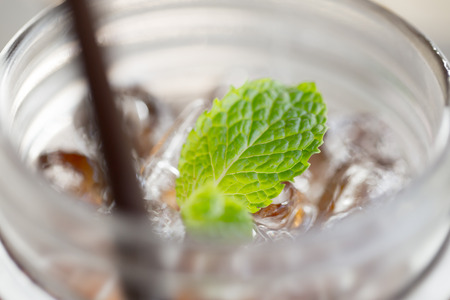 iced tea with blue straw and mintの写真素材