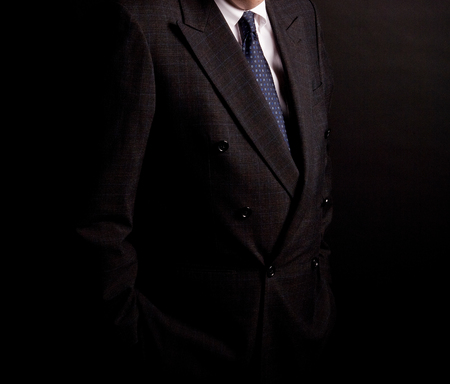 man in suit on a black background. studio shotの写真素材