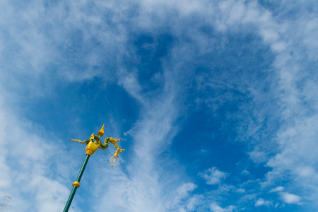 naga light pole decoration with blue sky background at nongkhai thailandの写真素材