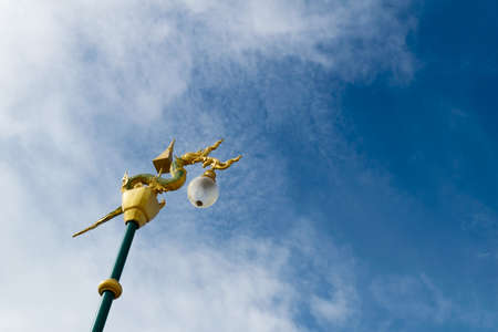 naga light pole decoration with blue sky background at nongkhai thailandの写真素材