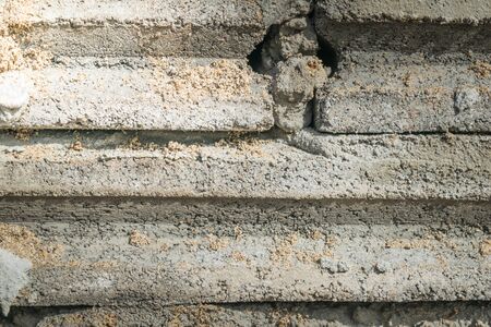 crude brick and sand  background texture with light from cornerの写真素材