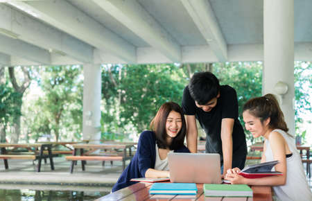 Young Students Group Consult with School Folders,Laptop Computer in Education Campus Universityの写真素材