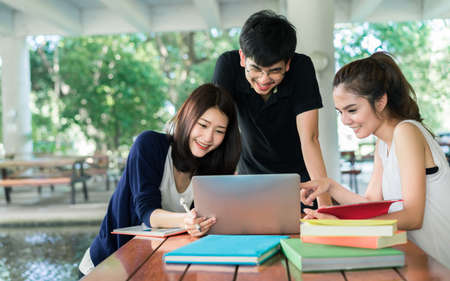 Young Students Group Consult with School Folders,Laptop Computer in Education Campus Universityの写真素材