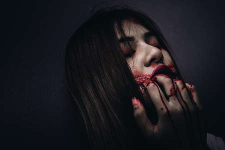 Zombie women death ghost eating with blood, darkness background, horror halloween festival conceptの写真素材