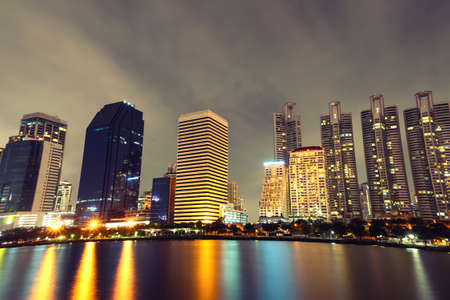 Bangkok thailand cityscape with water reflection at blue night skyの写真素材