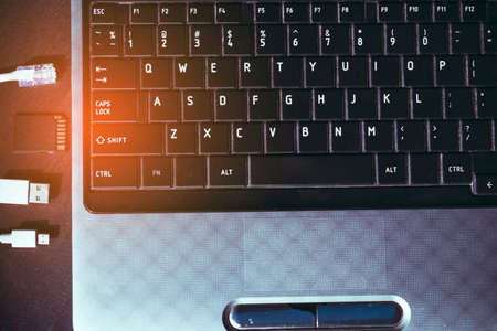 Laptop computer notebook for working business technology with Lan cable connectors, SD Card, Cable USB and Micro type on wooden table side viewの写真素材