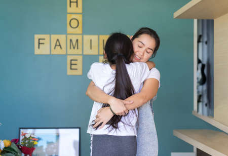 Mom hugging children girl after school in home family lover or mother day happiness concept.の写真素材