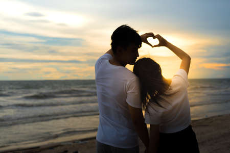 Young man and girl couple romantic dancing love leisure in celebration before married happy and fun at beach sunset vacation holidays, valentine day concept.の写真素材