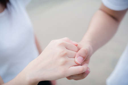 Young man holding hand with girlの写真素材