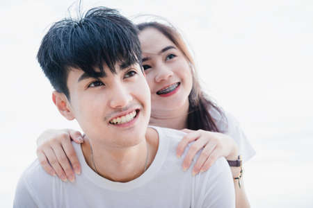 Young man and girl Couple in love selfie camera at beachの写真素材