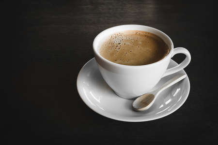 Capuccino, mocha, latte,americano, espresso hot coffee aroma in cup breakfast morning drink on wooden table vintage bar windows in cafe shop with newspaper restaurant background,copy space the left.の写真素材