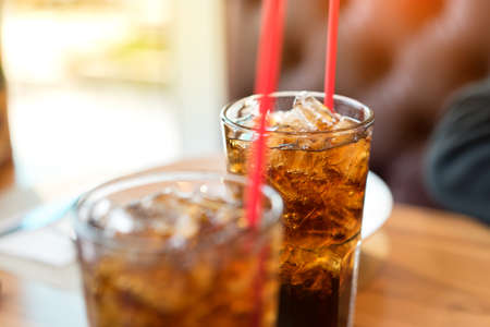 Double soft drink carbonated fresh food soda, white dish on wooden table with handsome man sitting ...
