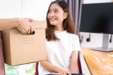 Young asian girl together freelancer business private working at home office with laptop, note, coffee, packaging sort box delivery online market on purchase orders to customer.の写真素材