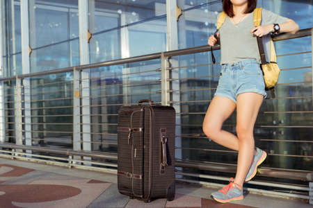 Young girl asian traveler walking with carrying hold suitcase luggage and passenger for tour travel booking ticket flight in airport international vacation time in holiday rest and relaxation.の写真素材