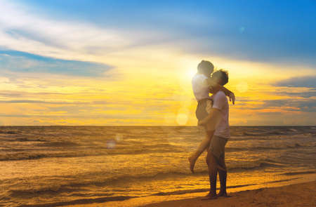 Young man and girl couple romantic leisure in celebration before married happy and fun at beach sunset vacation holidays, valentine day concept silhouette.の写真素材