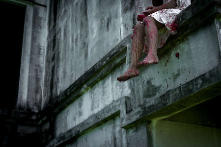 Zombie woman or ghost death with blood on house of ruin nightmare, horror of scary fear on hell is monster devil in halloween festival.の写真素材