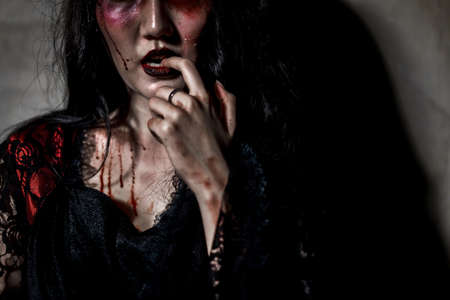 Zombie women death or witch the ghost drain hand blood skin is screaming darkness and nightmare, horror of scary fear on hell is monster in halloween festival concept,copy space the right.の写真素材