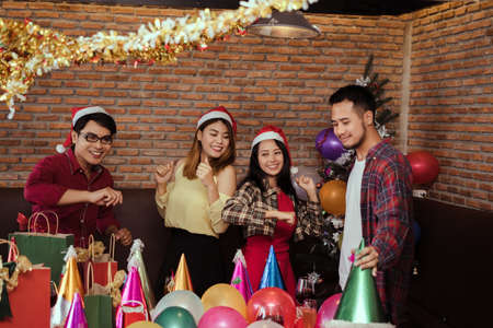 Young men and women group x'mas party together  with dancing happy and fun in new year celebrateの写真素材