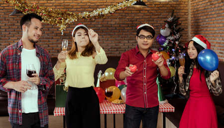 Young men and women group x'mas party together  with dancing drinking wine happy and fun in new year celebrationの写真素材