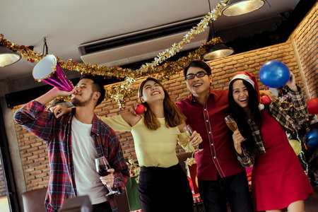 Young men and women group x'mas party together  with dancing drinking wine happy and fun in new year cerebrateの写真素材