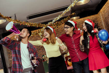 Young men and women group x'mas party together  with dancing drinking wine happy and fun in new year cerebrateの写真素材