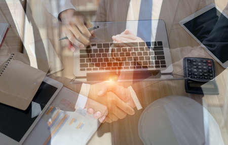 Two Businessman handshake teamwork partner and boss clap for working success project finish complete, double exporsureの写真素材