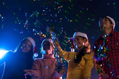 Young Asian group man and women dancing new year christmas party in midnight december at nightclub countdown luxuryの写真素材