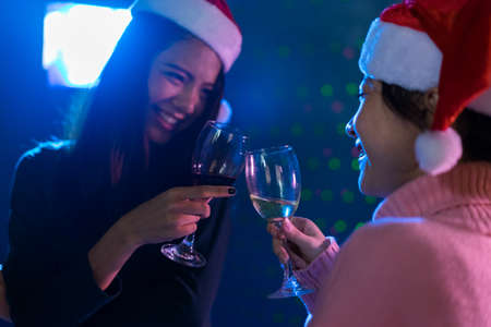 Young women asian together drinking cocktail or champagne in nightclub celebration new year christmas partyの写真素材