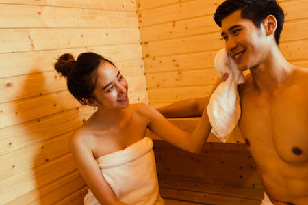Sauna spa couple woman massage man together sitting  room with hot warm steam happy relaxing, resting for health care and skin in holiday at cabinの写真素材