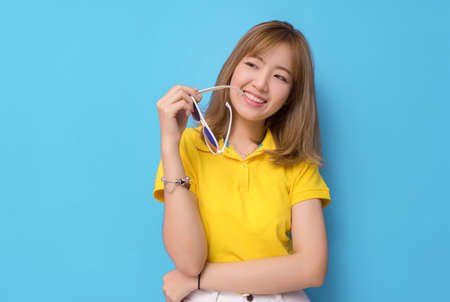 Fashion portrait smile sunglasses of young asian girl beautiful with relax dress yellow shirt and...