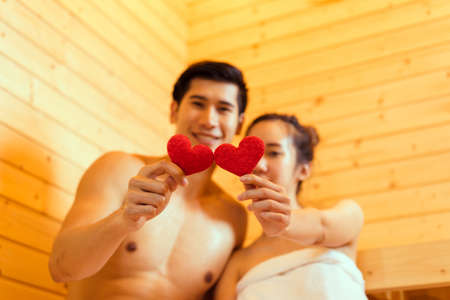 Couple at sauna spa healthy concept, Young asian man handsome and woman beautiful together sitting in room with hot warm steam happy relaxing, resting for health care and skin in holiday の写真素材